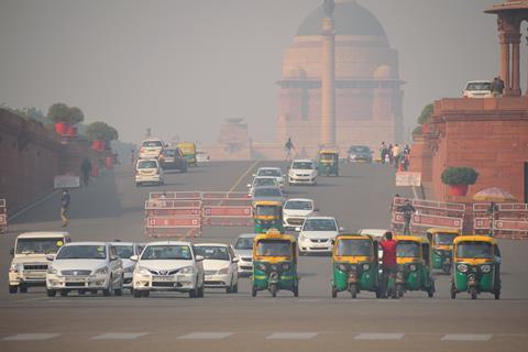 Delhi, India - November 21, 2017: Vehicles traveling on the road in heavy smog.